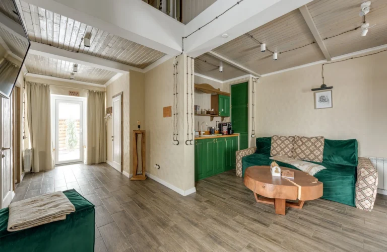 Finished living room with softly painted walls and green cabinetry