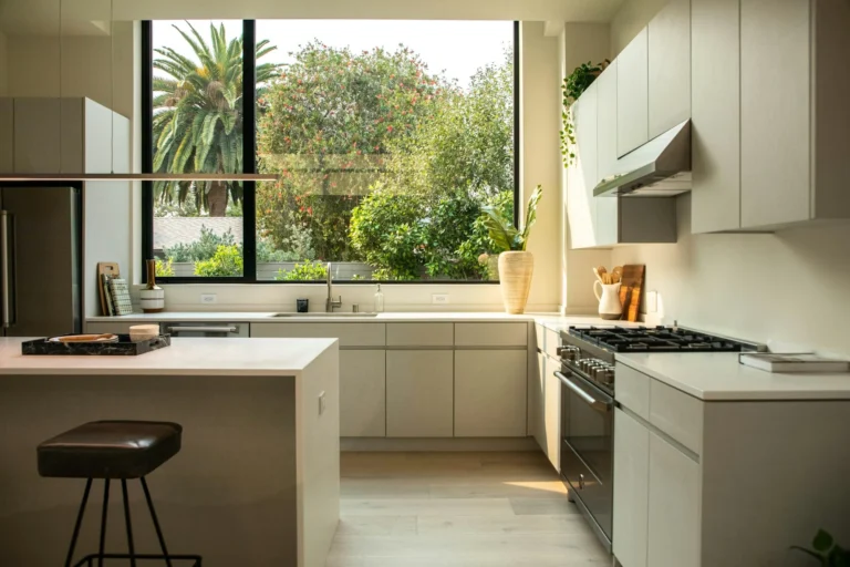 Real photograph of a modern fitted kitchen with an island and large window